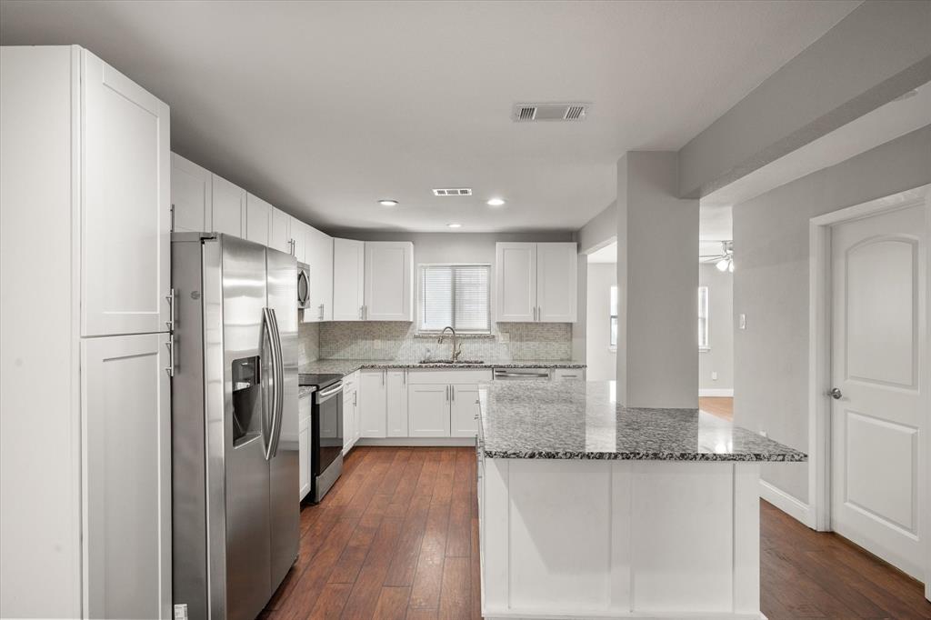 207 East Harwood Road, Unit 10 Euless, TX 76039 - Photo 7 of 34 a kitchen with counter top space cabinets and stainless steel appliances