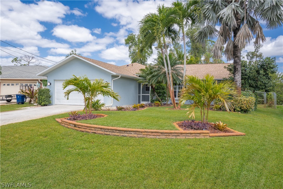 18367 Tulip Road Fort Myers, FL 33967 - Photo 2 of 13 a front view of a house with a yard