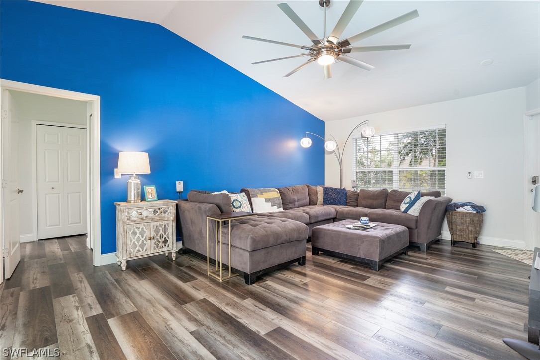 18367 Tulip Road Fort Myers, FL 33967 - Photo 5 of 13 a living room with couches chairs and a large window with wooden floor