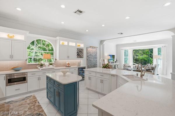 2026 Merlin Court Naples, FL 34105 - Photo 12 of 43 a kitchen with sink stove and cabinets