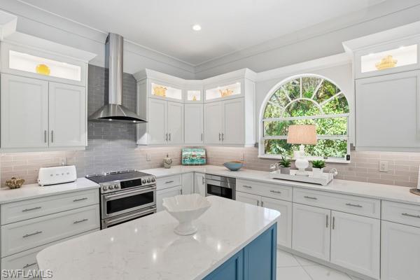 2026 Merlin Court Naples, FL 34105 - Photo 13 of 43 a kitchen with white cabinets appliances and windows