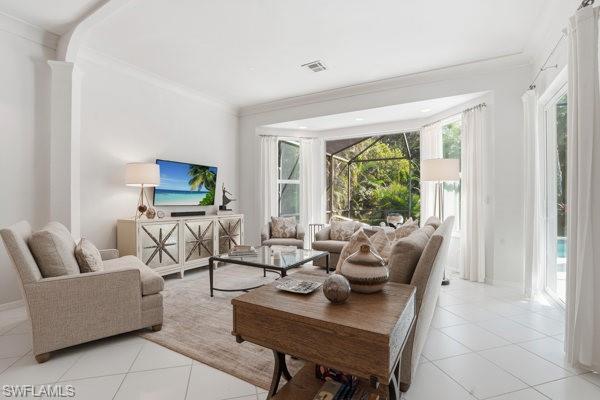 2026 Merlin Court Naples, FL 34105 - Photo 16 of 43 a living room with furniture and a flat screen tv