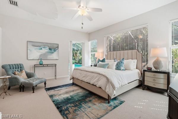 2026 Merlin Court Naples, FL 34105 - Photo 21 of 43 a bedroom with a bed and a chandelier