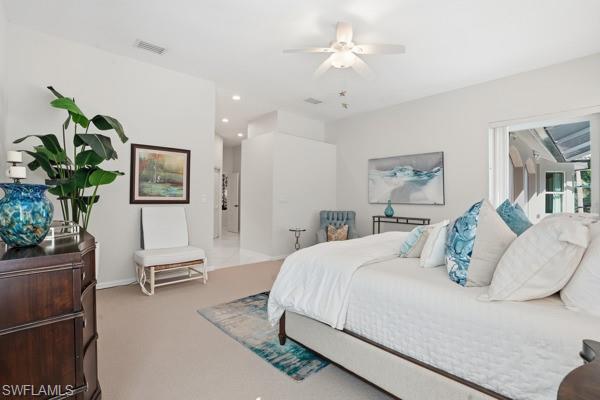 2026 Merlin Court Naples, FL 34105 - Photo 22 of 43 a bedroom with a large bed and a chandelier