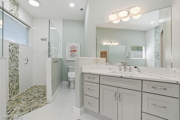 2026 Merlin Court Naples, FL 34105 - Photo 23 of 43 a bathroom with a sink a toilet and shower