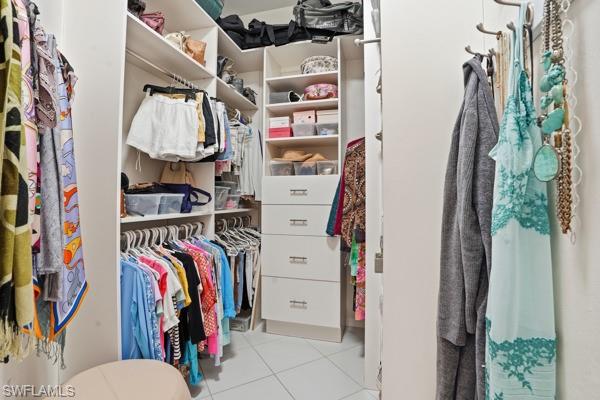 2026 Merlin Court Naples, FL 34105 - Photo 26 of 43 a view of walk in closet with clothes and shoes