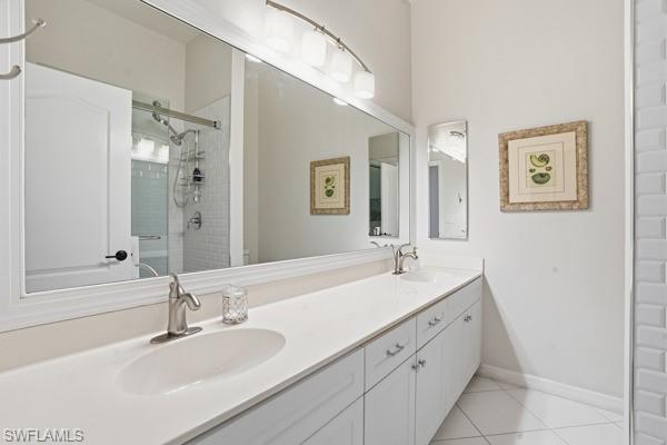 2026 Merlin Court Naples, FL 34105 - Photo 27 of 43 a bathroom with a sink and a mirror