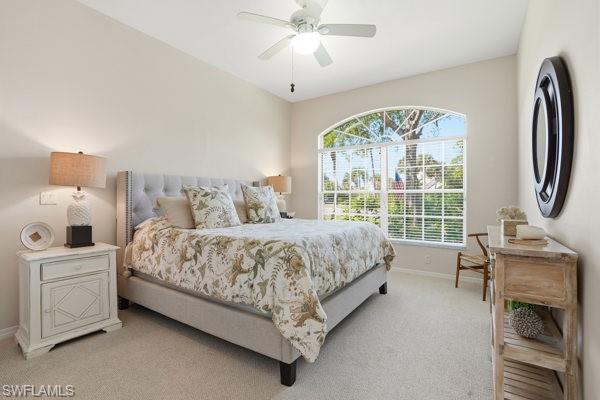 2026 Merlin Court Naples, FL 34105 - Photo 28 of 43 a bedroom with a bed chair and a large window