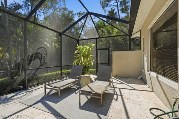 2026 Merlin Court Naples, FL 34105 - Photo 39 of 43 a backyard of a house with table and chairs