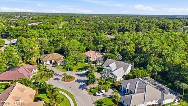 2026 Merlin Court Naples, FL 34105 - Photo 41 of 43 a view of a garden with a building in the background