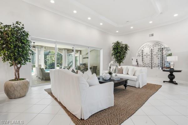 2026 Merlin Court Naples, FL 34105 - Photo 8 of 43 a living room with furniture potted plant and a large window