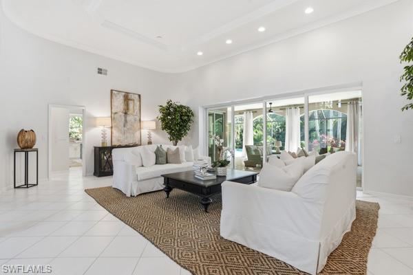 2026 Merlin Court Naples, FL 34105 - Photo 10 of 43 a living room with furniture large windows and a rug