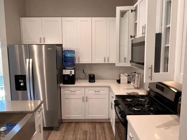 a kitchen with stainless steel appliances a refrigerator stove and sink