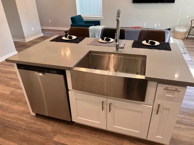 a kitchen with stainless steel appliances granite countertop a sink and a stove