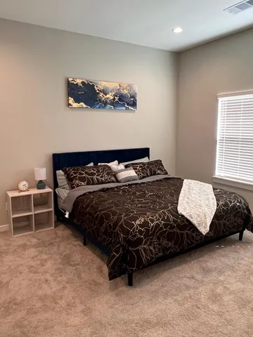 a bedroom with a bed and window