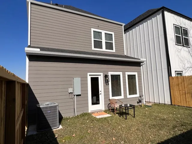 a backyard of a house with table and chairs