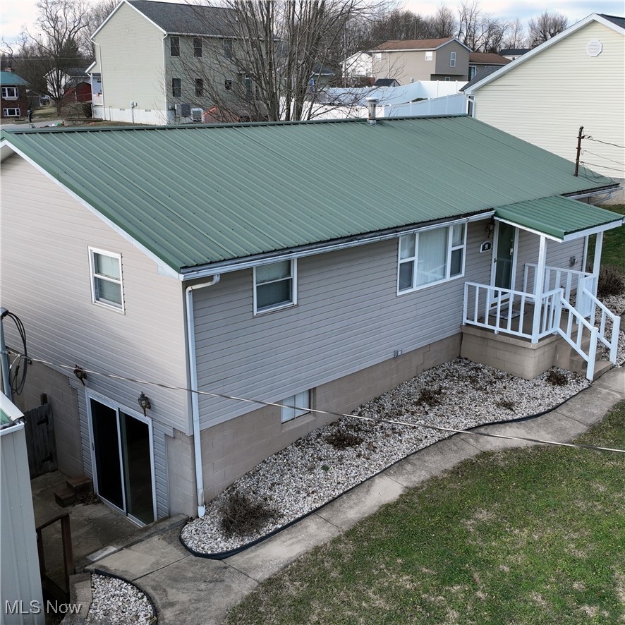91 Mike Street Washington, WV 26181 - Photo 10 of 42 View of home's exterior with a porch and a metal roof