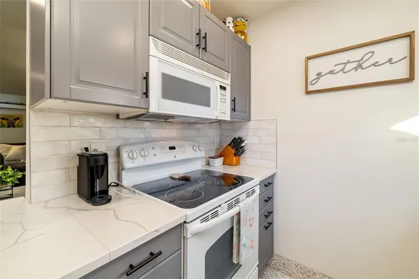 a kitchen with stainless steel appliances a refrigerator and a stove top oven