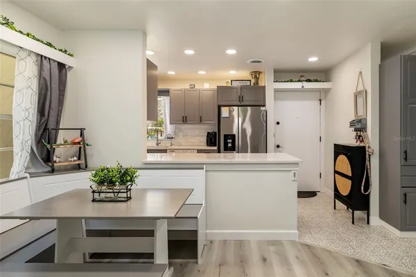 a living room with furniture and kitchen view