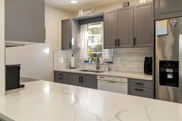 a bathroom with a sink and mirror with toilet