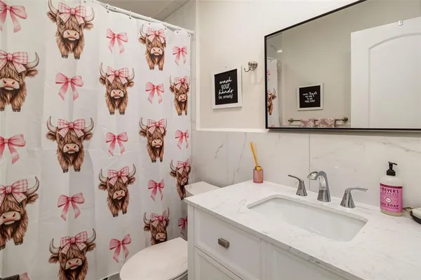 a bedroom with a bed a table and window