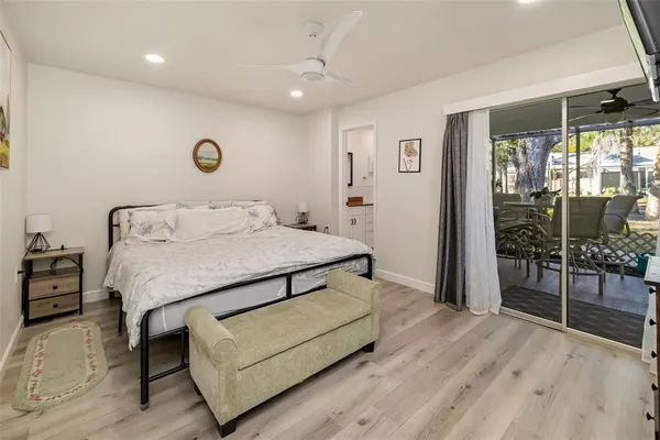 a bedroom with a bed and paintings on the wall