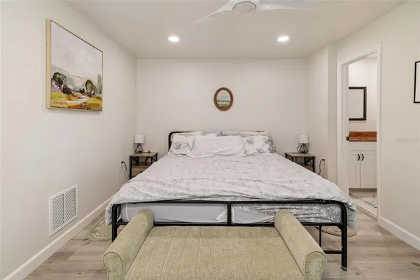 a bedroom with a bed and a view of kitchen
