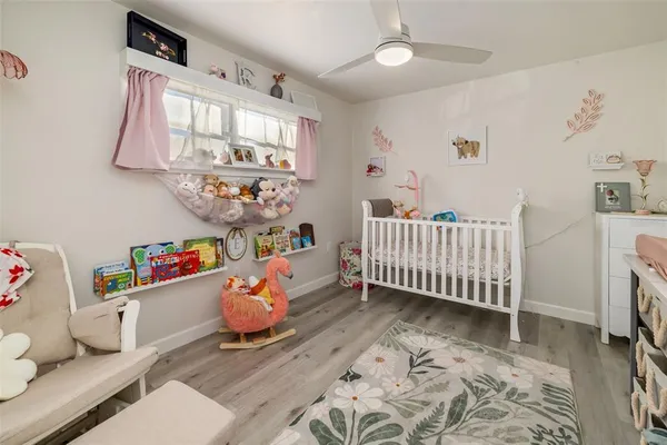 a bedroom with furniture and a wooden floor