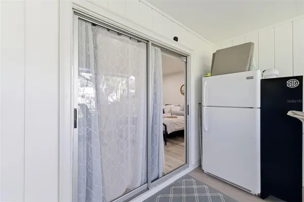 a backyard of a house with barbeque oven table and chairs