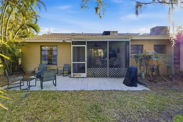 a view of a house with backyard and porch