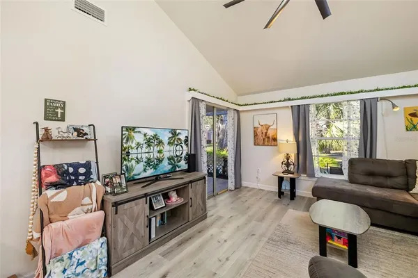 a kitchen with white cabinets and refrigerator