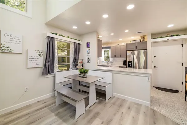 a large white kitchen with a large window