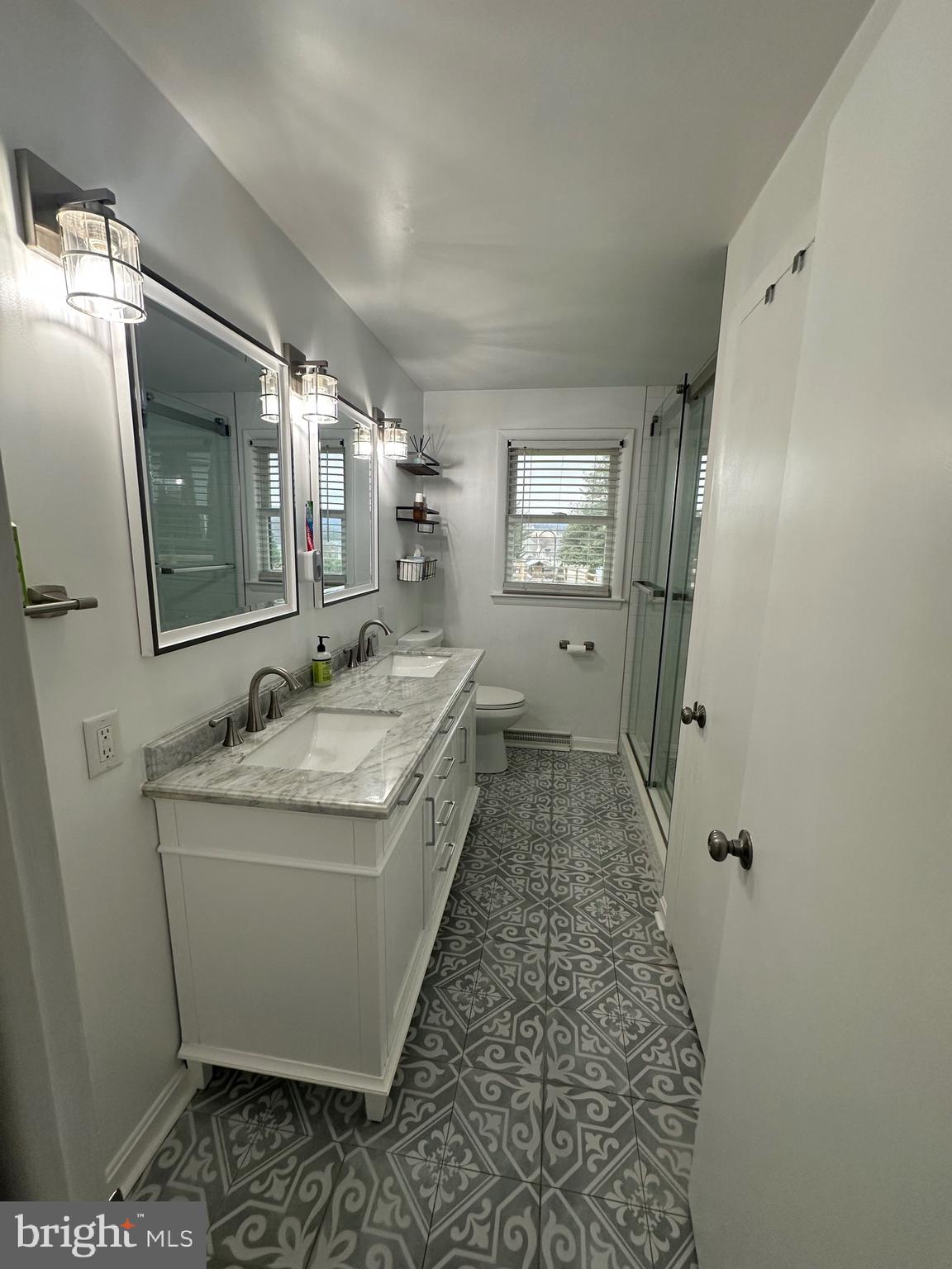2642 Canada Hill Road Myersville, MD 21773 - Photo 19 of 33 a spacious bathroom with a granite countertop sink a mirror and shower