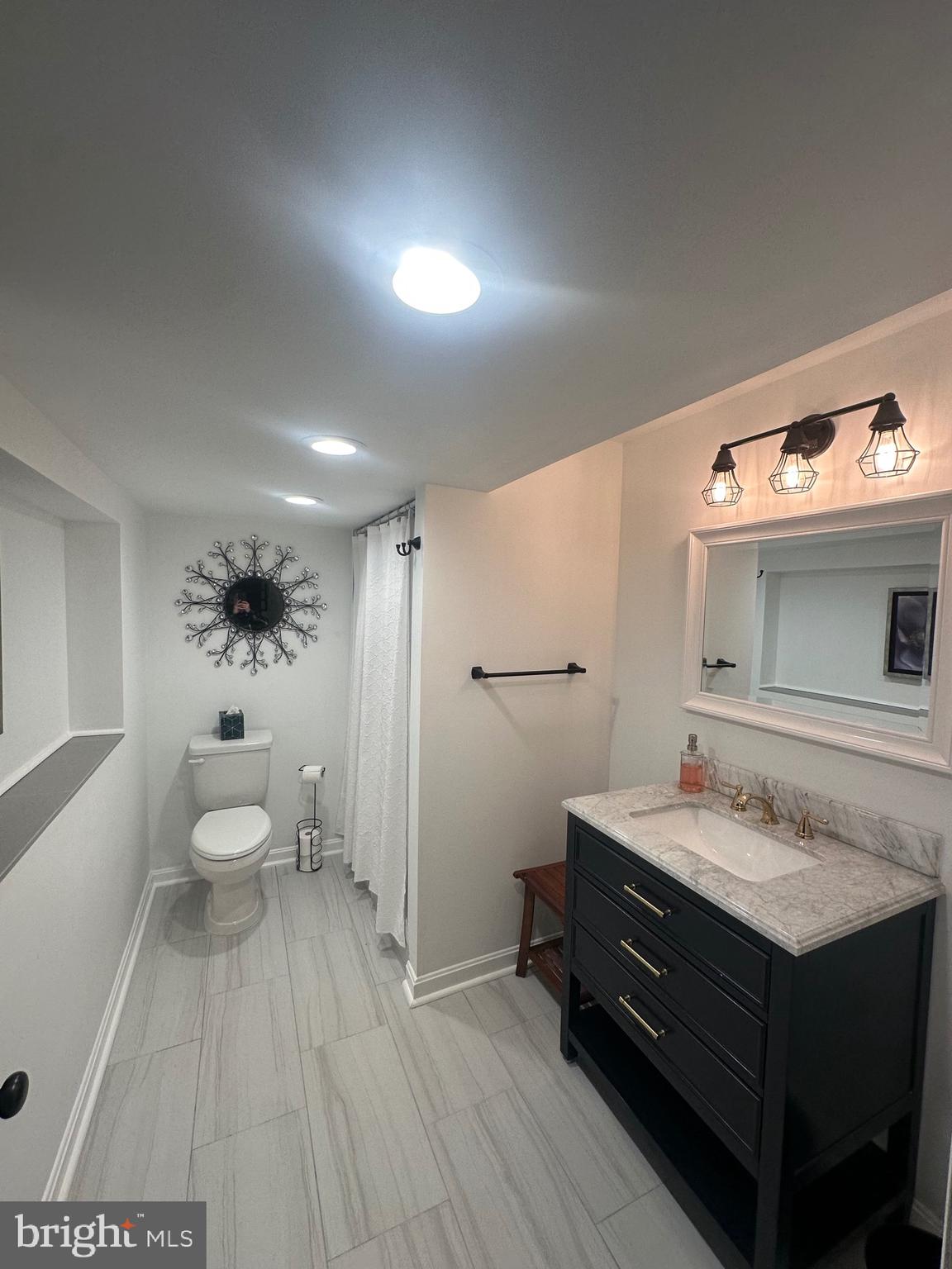 2642 Canada Hill Road Myersville, MD 21773 - Photo 23 of 33 a bathroom with a sink mirror and toilet