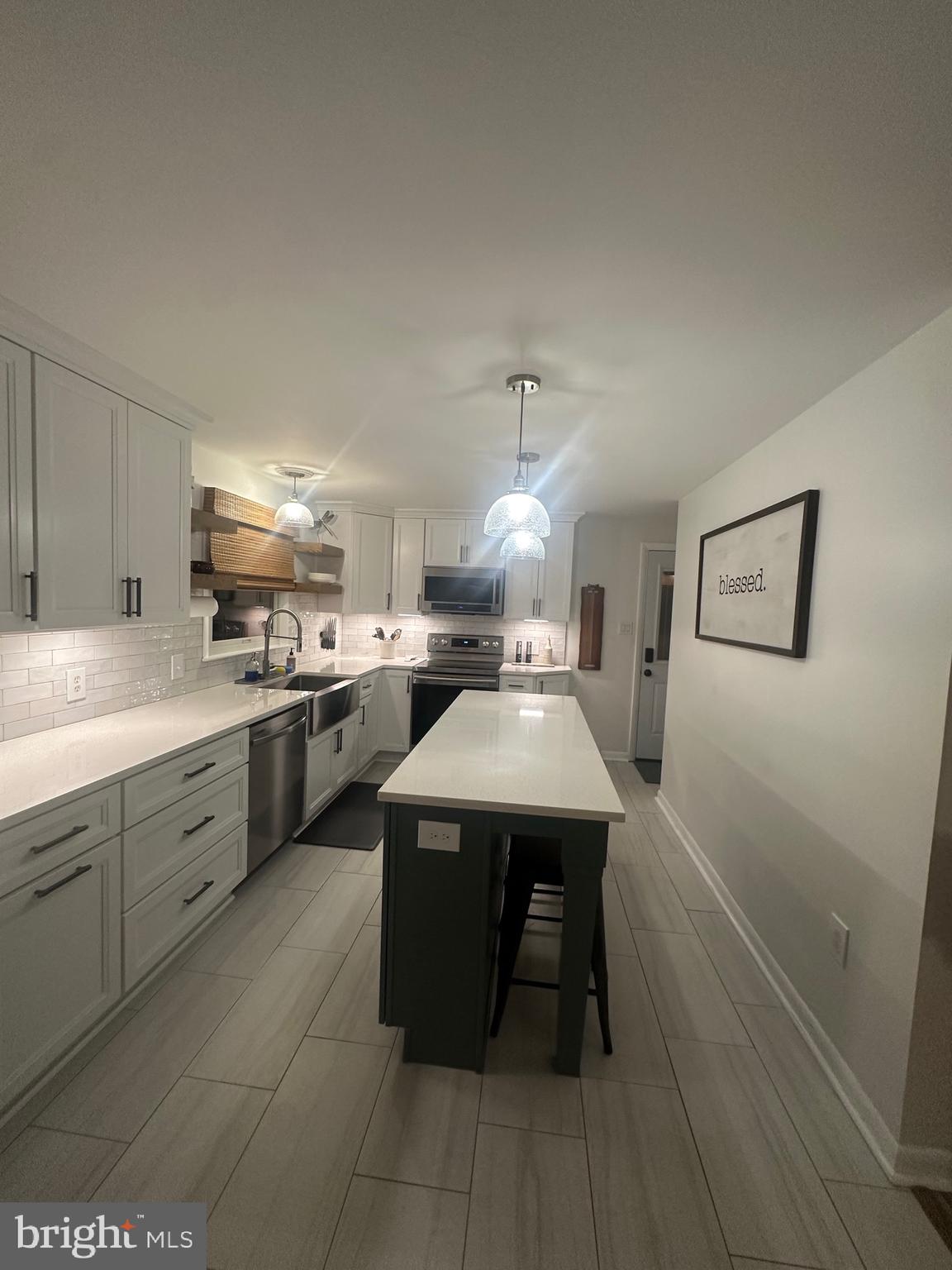 2642 Canada Hill Road Myersville, MD 21773 - Photo 8 of 33 a kitchen with a sink a stove cabinets and wooden floor