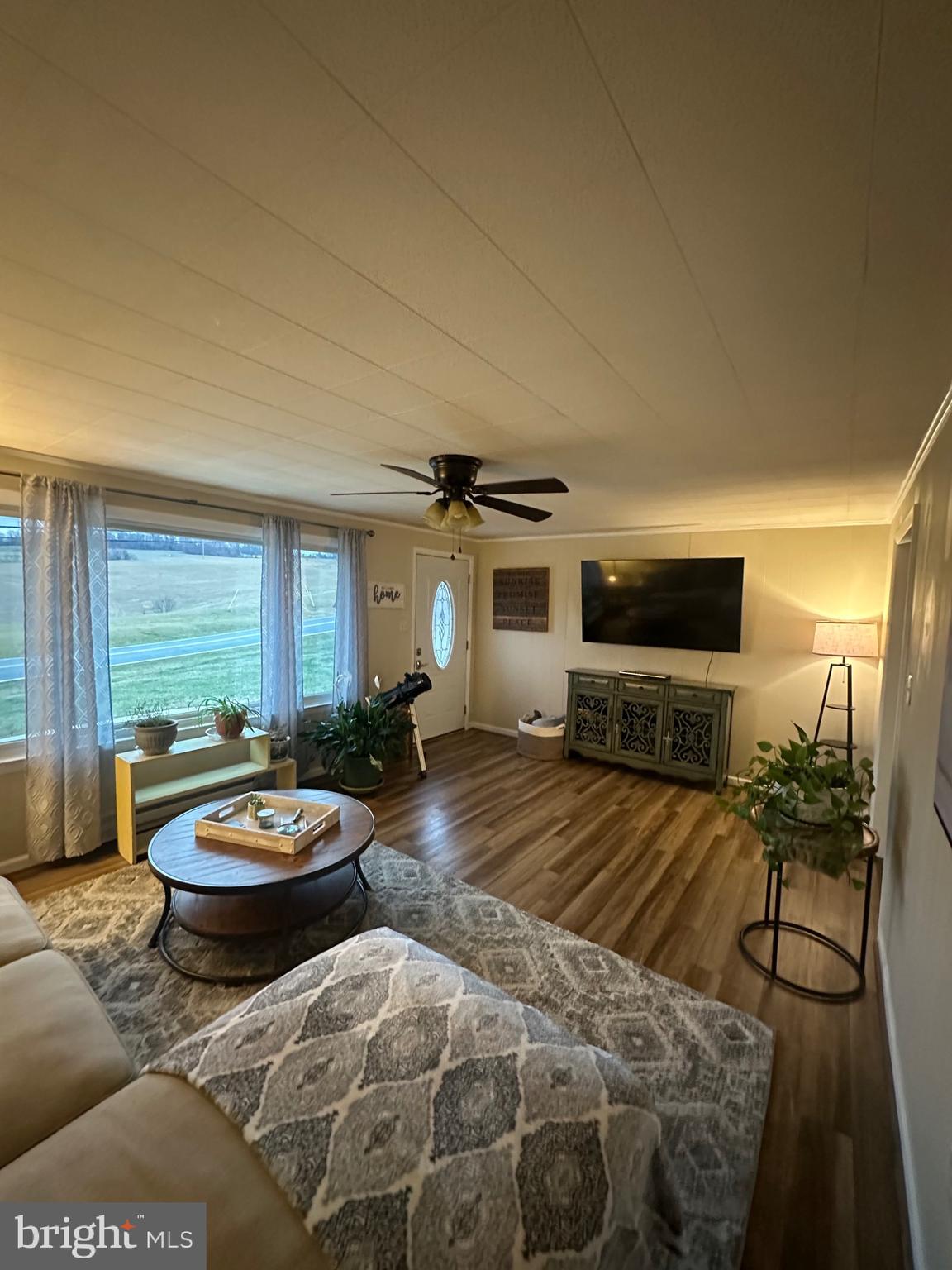 2642 Canada Hill Road Myersville, MD 21773 - Photo 10 of 33 a living room with furniture a flat screen tv and a large window