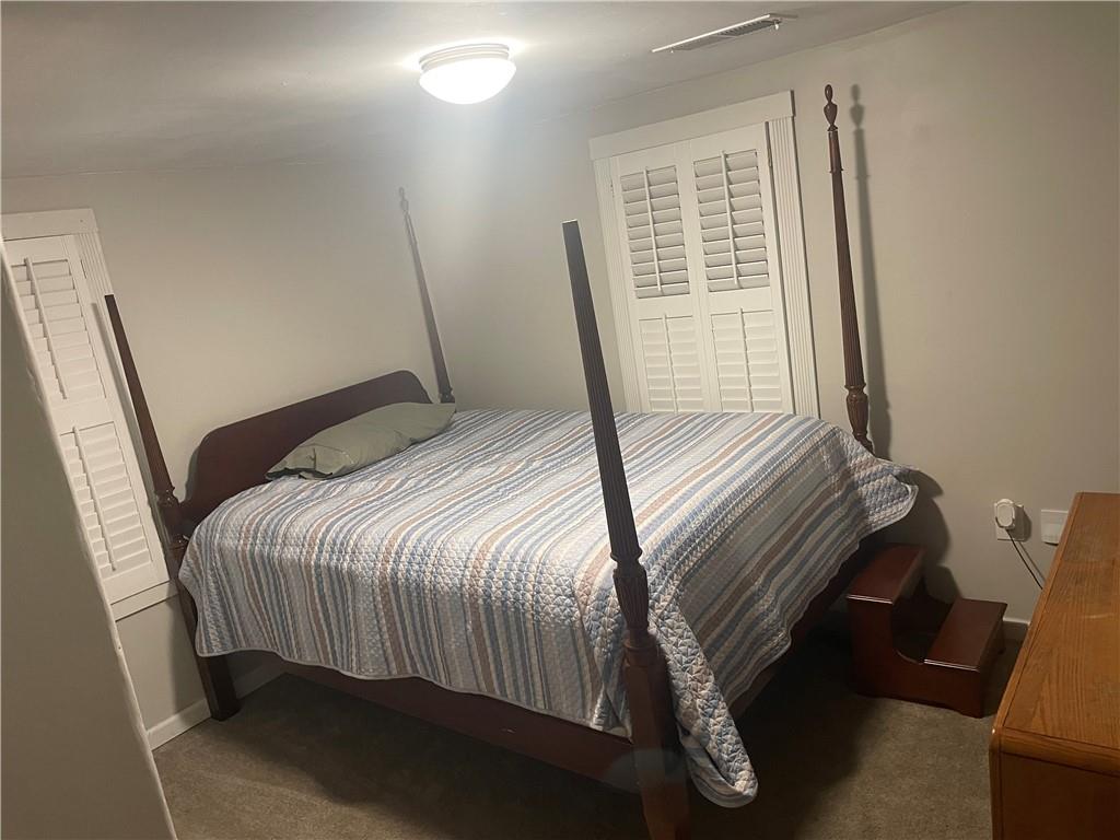 71 McGuire Road Dallas, GA 30157 - Photo 14 of 26 a bedroom with a bed and a window