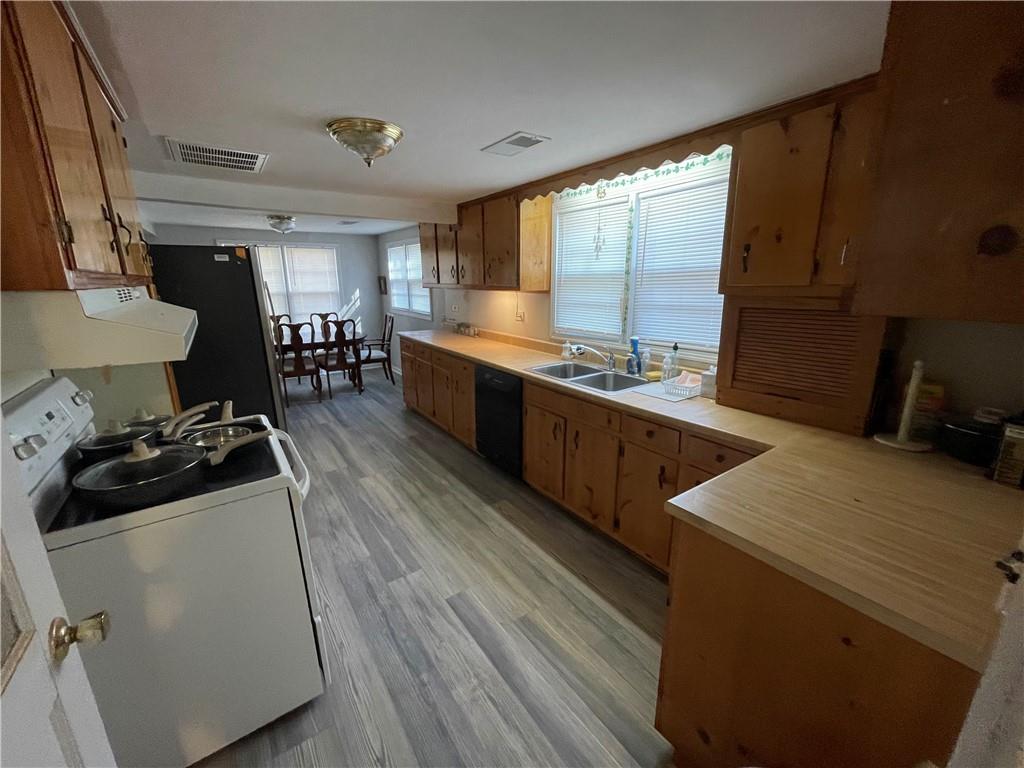 71 McGuire Road Dallas, GA 30157 - Photo 22 of 26 a kitchen with stainless steel appliances a sink stove and cabinets