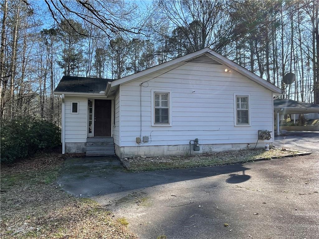 71 McGuire Road Dallas, GA 30157 - Photo 24 of 26 a view of a brick house with large windows