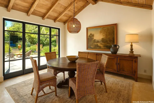 a backyard of a house with table and chairs