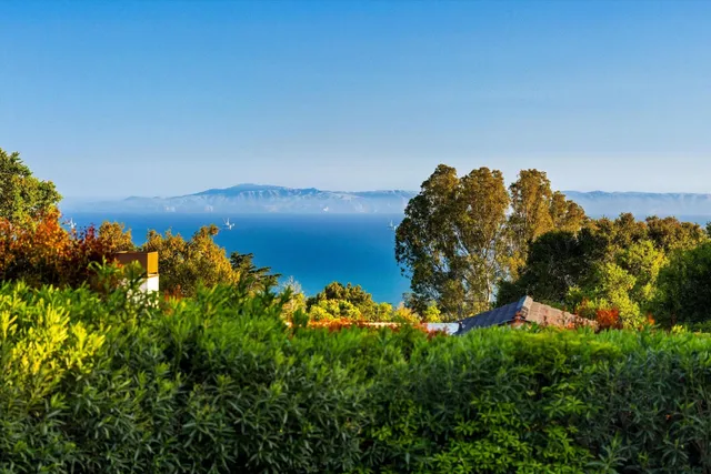 a spacious bedroom with a large bed and a large window