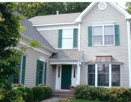 34 Wilton Hunt Road, Unit 17 Wilton, CT 06897 - Photo 1 of 1 a front view of a house with a yard