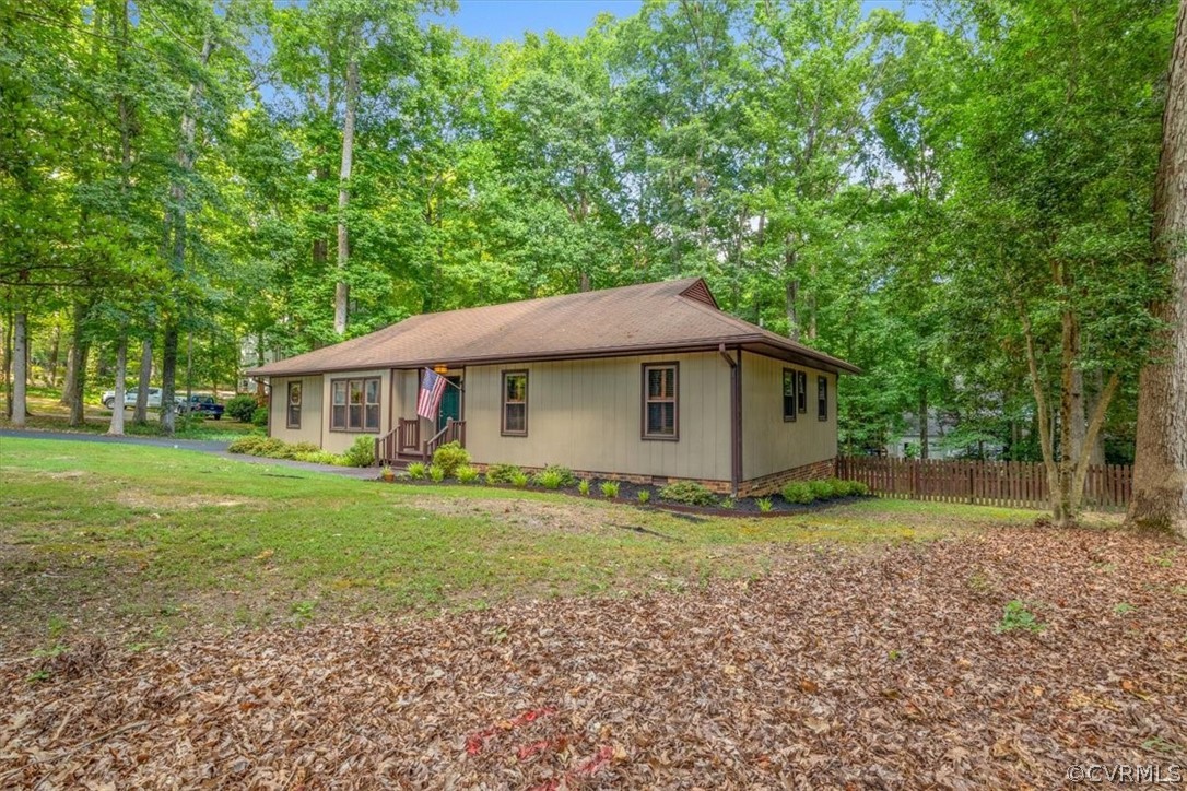 13919 Barnes Spring Road Midlothian, VA 23112 - Photo 24 of 25 a yellow and white house sitting in middle of the forest