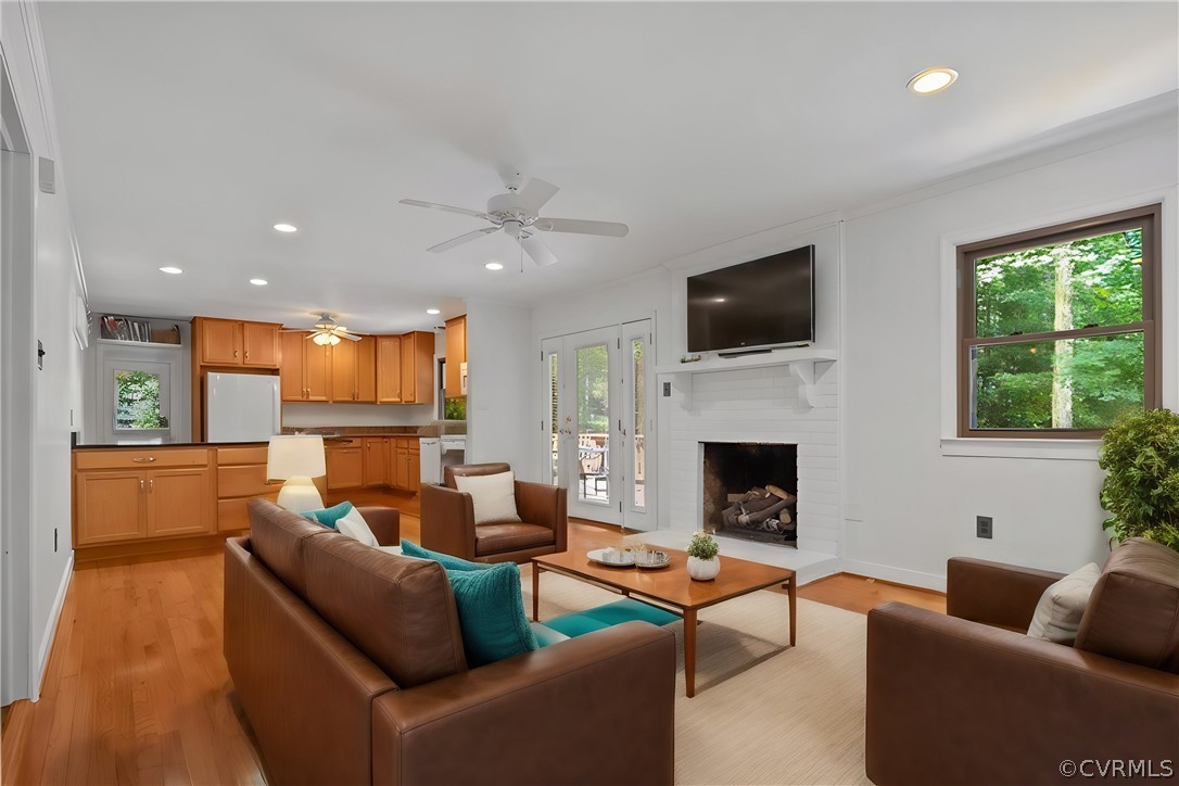 13919 Barnes Spring Road Midlothian, VA 23112 - Photo 5 of 25 a living room with furniture a fireplace and a flat screen tv