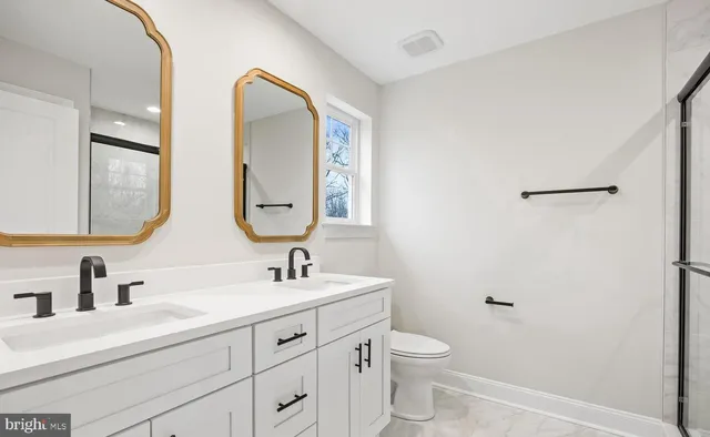 a bathroom with a double vanity sink and a mirror