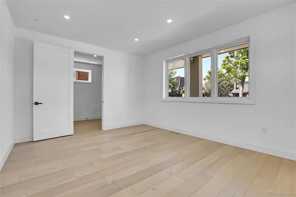 a view of a kitchen with wooden floor and electronic appliances