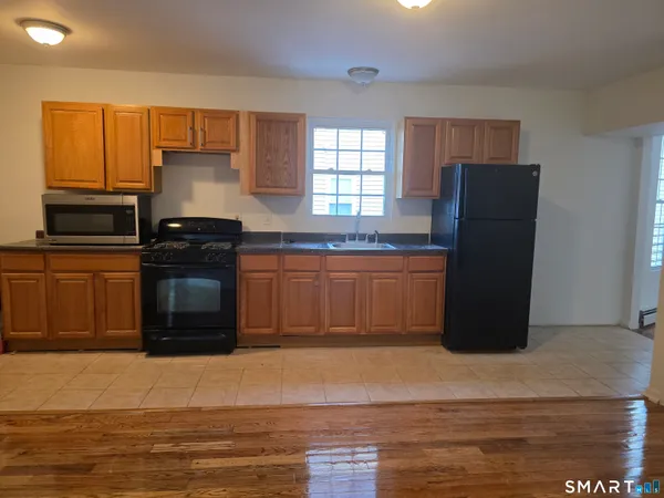 a kitchen with a refrigerator and a sink