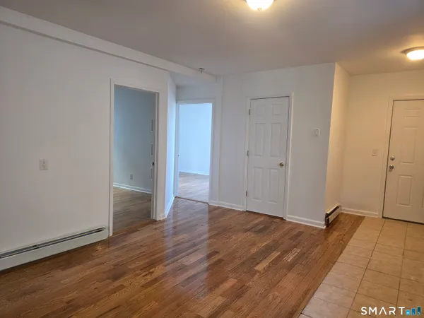 a view of a room with wooden floor