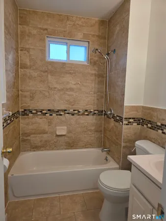 a bathroom with a sink a toilet and a bathtub