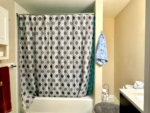 a bathroom with a sink toilet and shower
